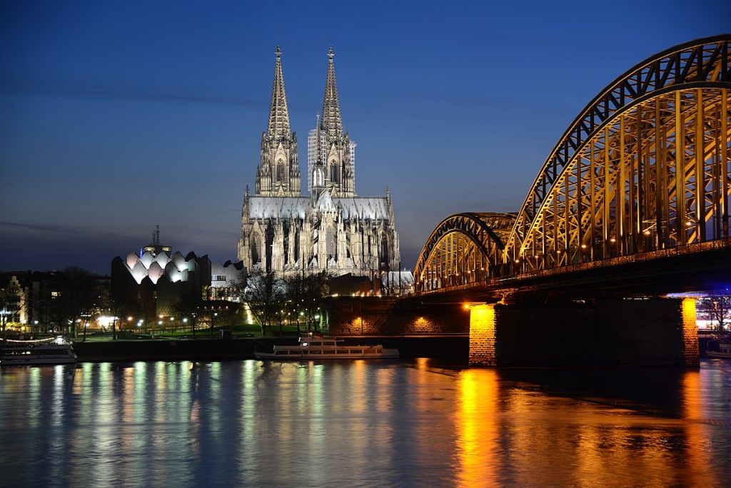 Cologne Cathedral at blue hour left Cologne philharmonic hall right Hohenzollern Bridge Germany